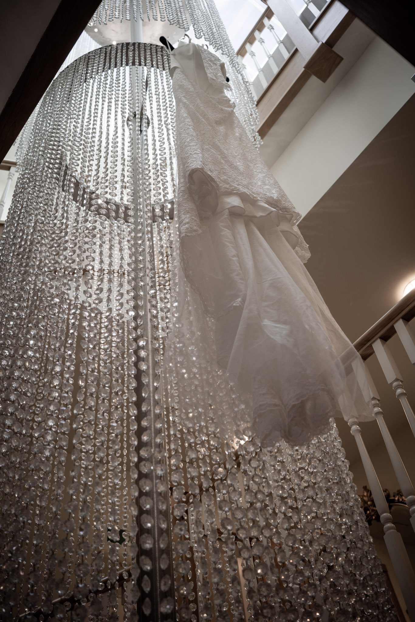 A wedding dress seen through a beaded curtain