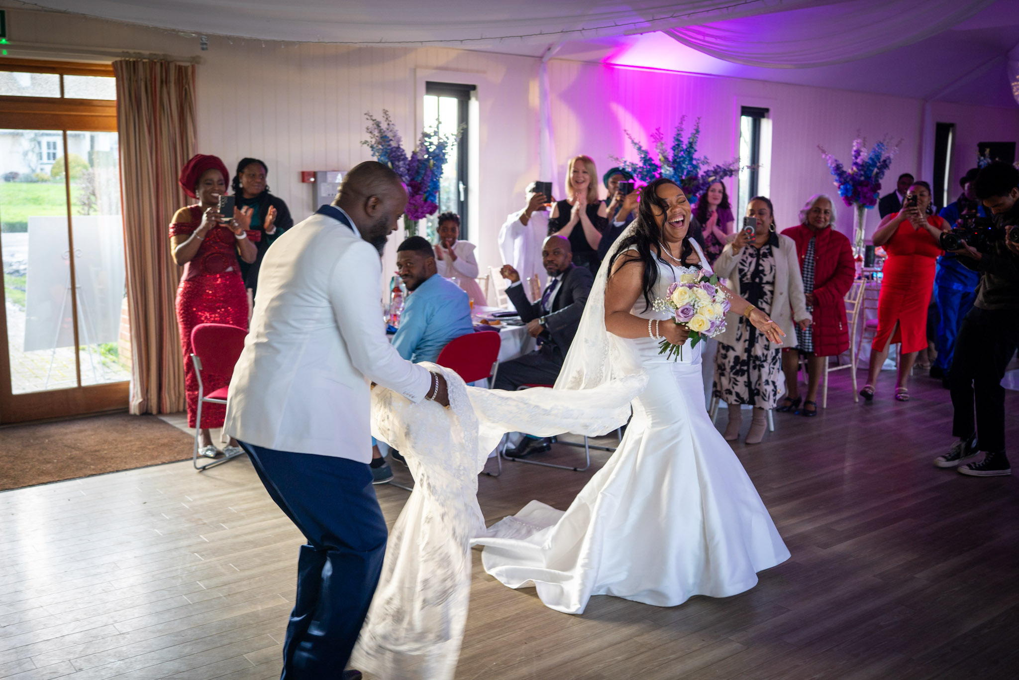 A bride and groom laughing during their reception