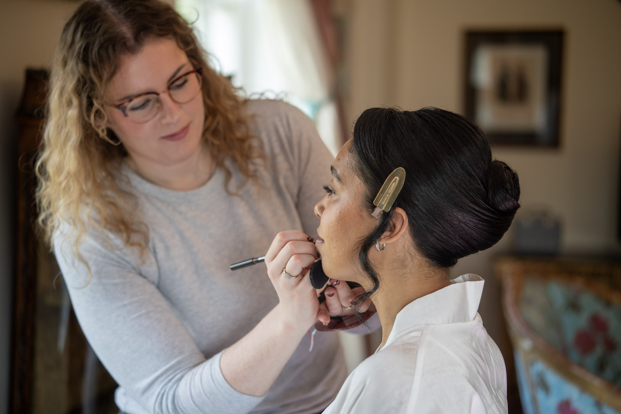 Bride having makeup applied