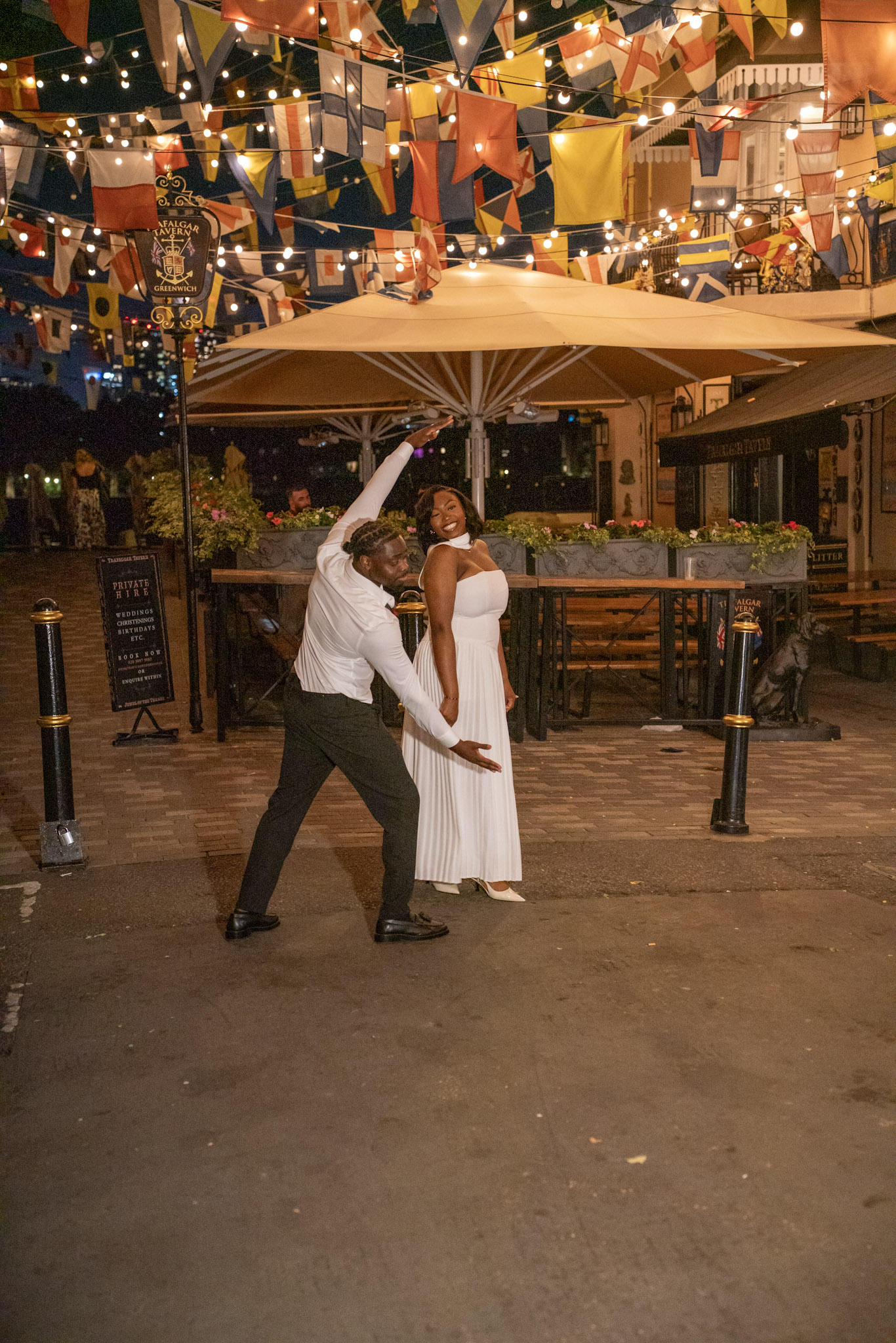 Bride and groom dancing outside