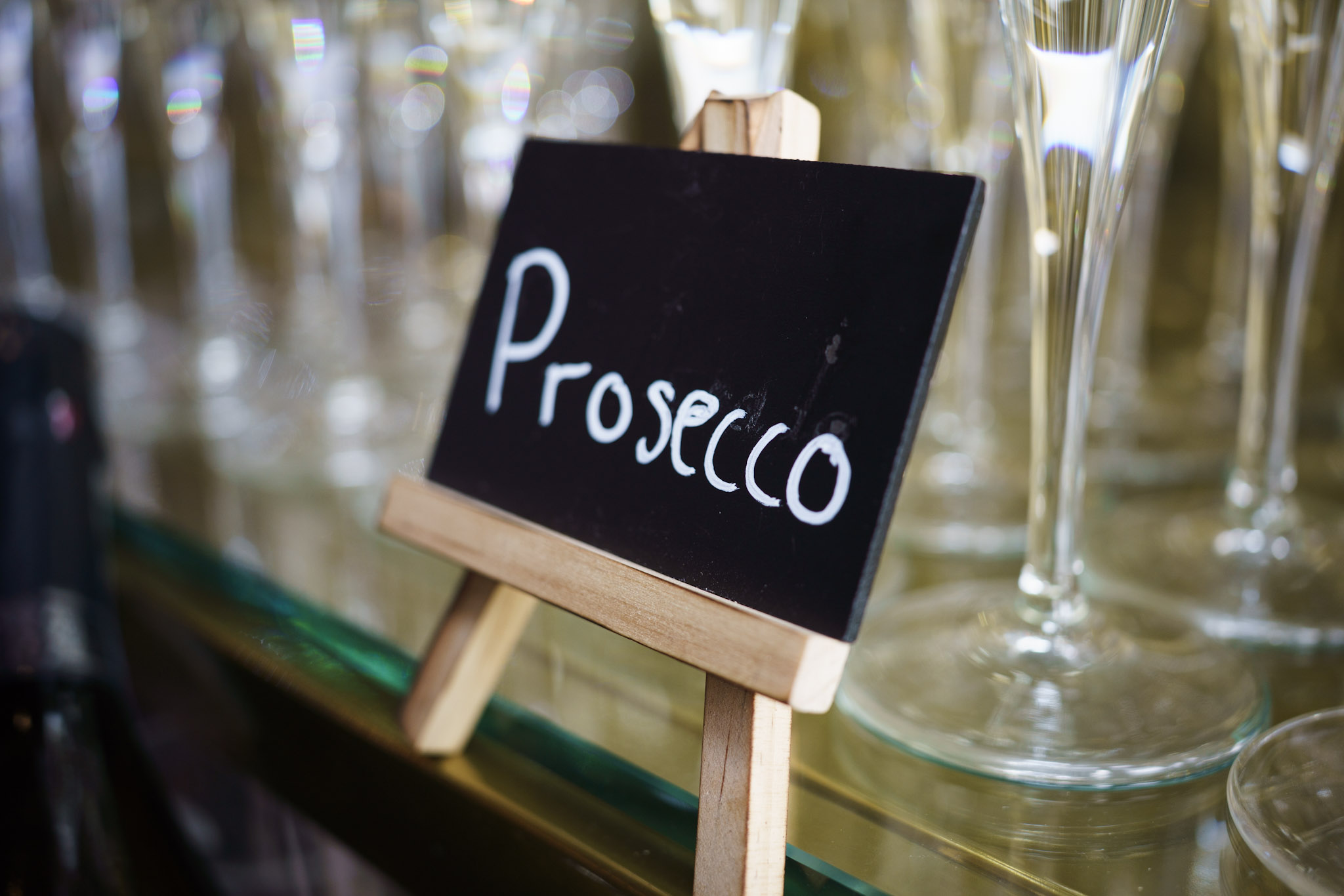 Prosecco sign beside reception glasses